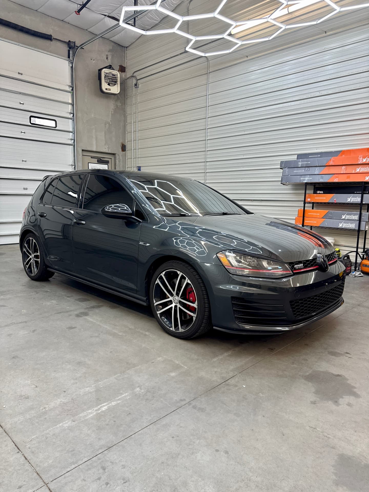 Grey Volkswagen Golf GTI with ceramic window tint inside the shop