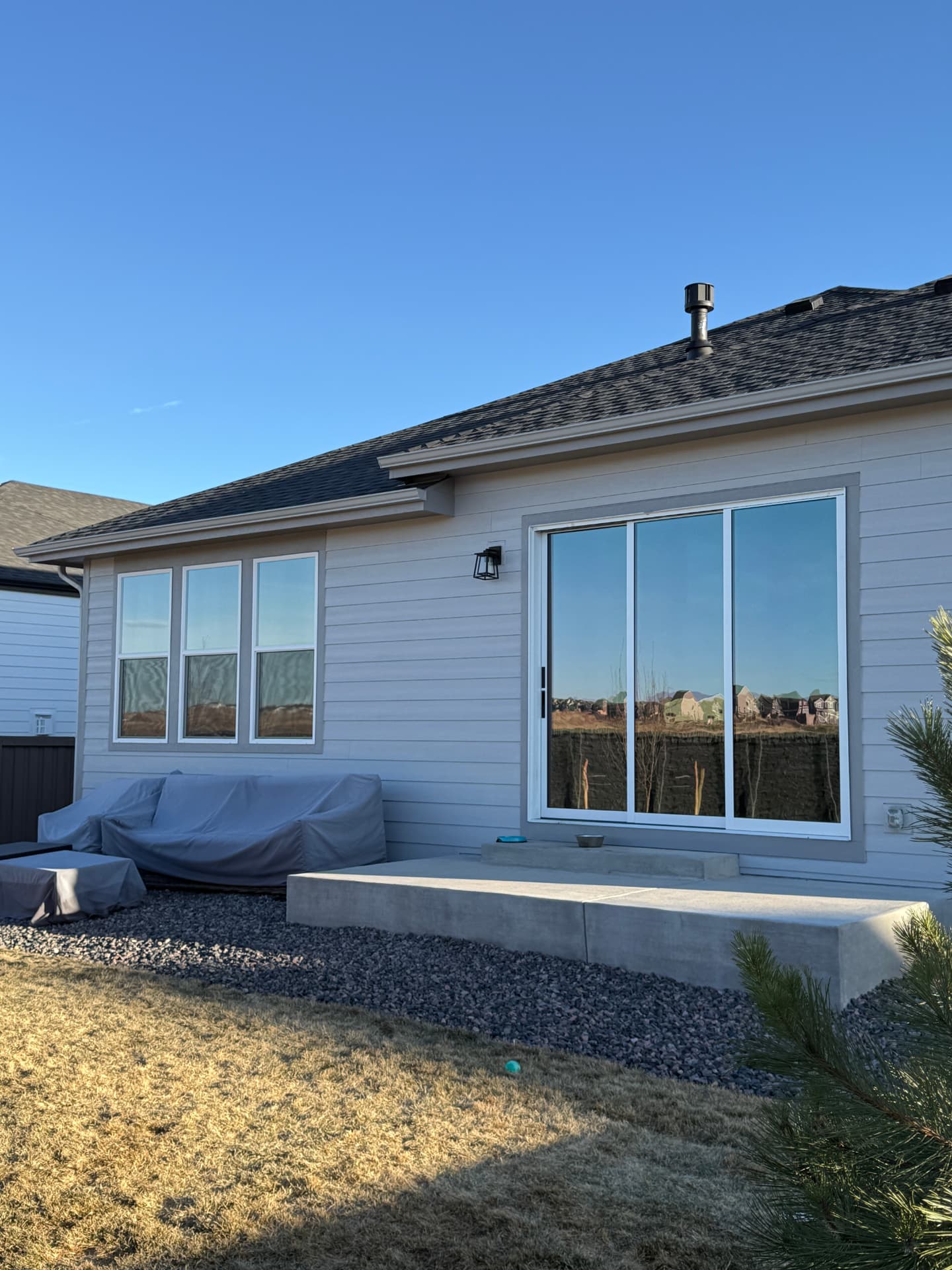 Castle Rock home exterior with ceramic window film on the patio slider and rear windows