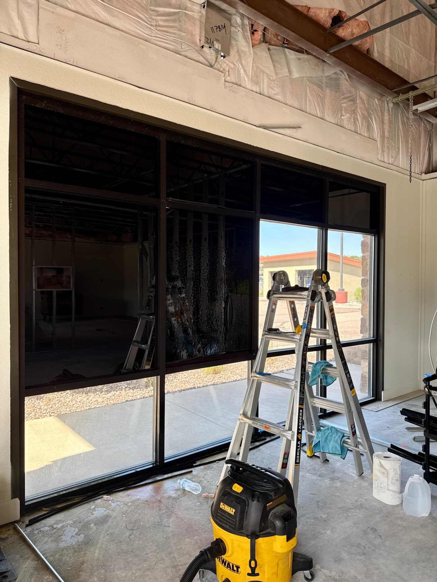 Commercial storefront window film installation in progress inside a new Douglas County build-out