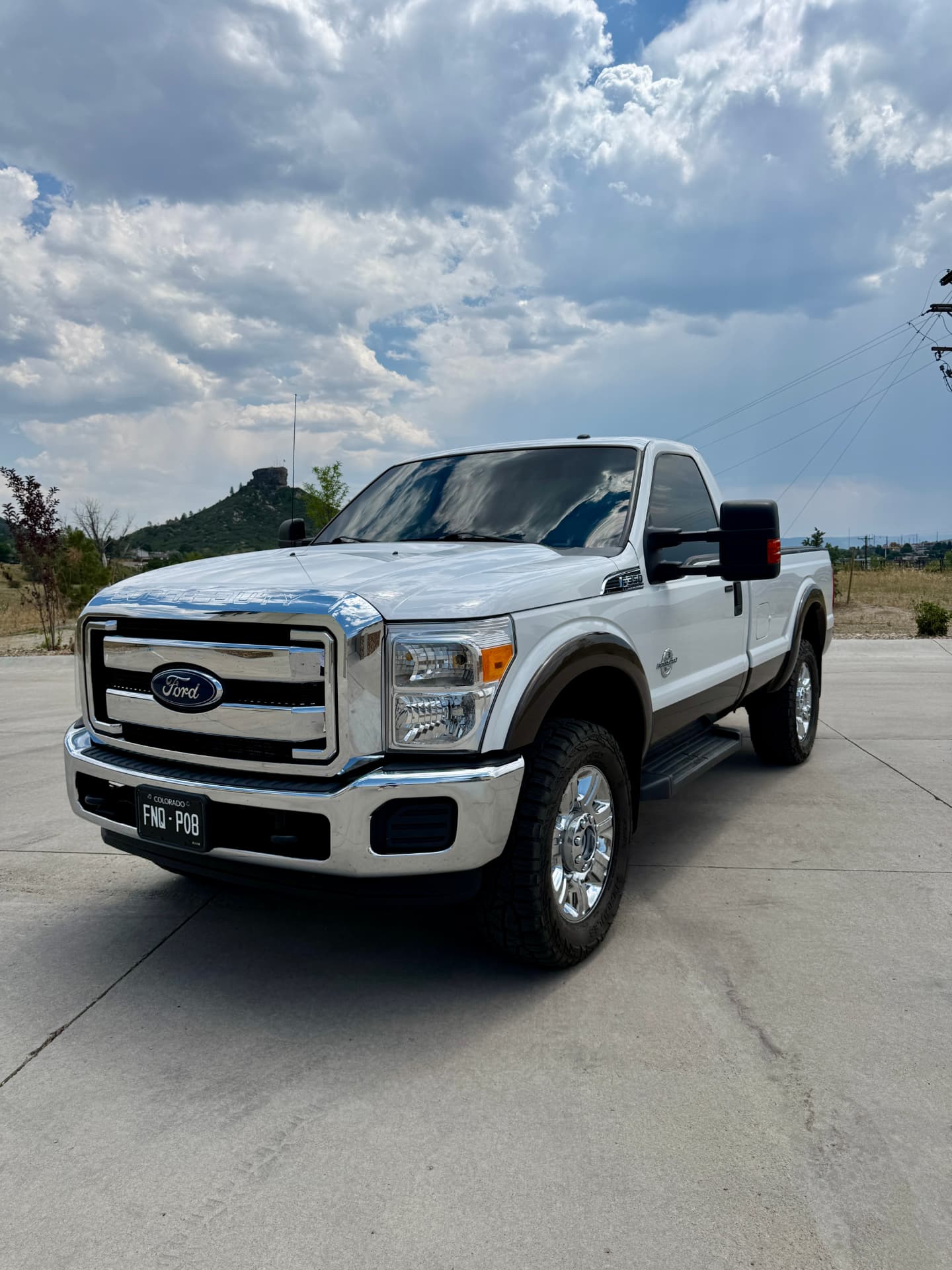 White Ford F-350 Super Duty with tinted windows near Castle Rock