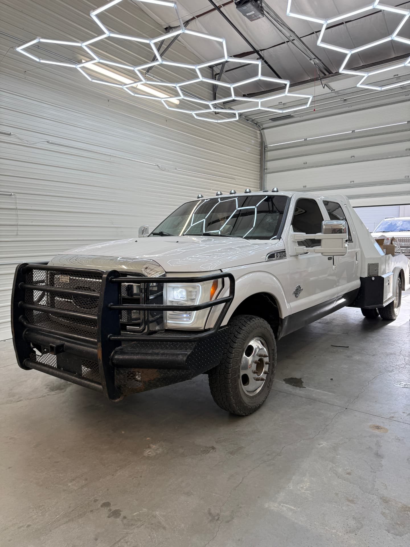 White Ford F-350 flatbed work truck with ceramic tint under the hex lights