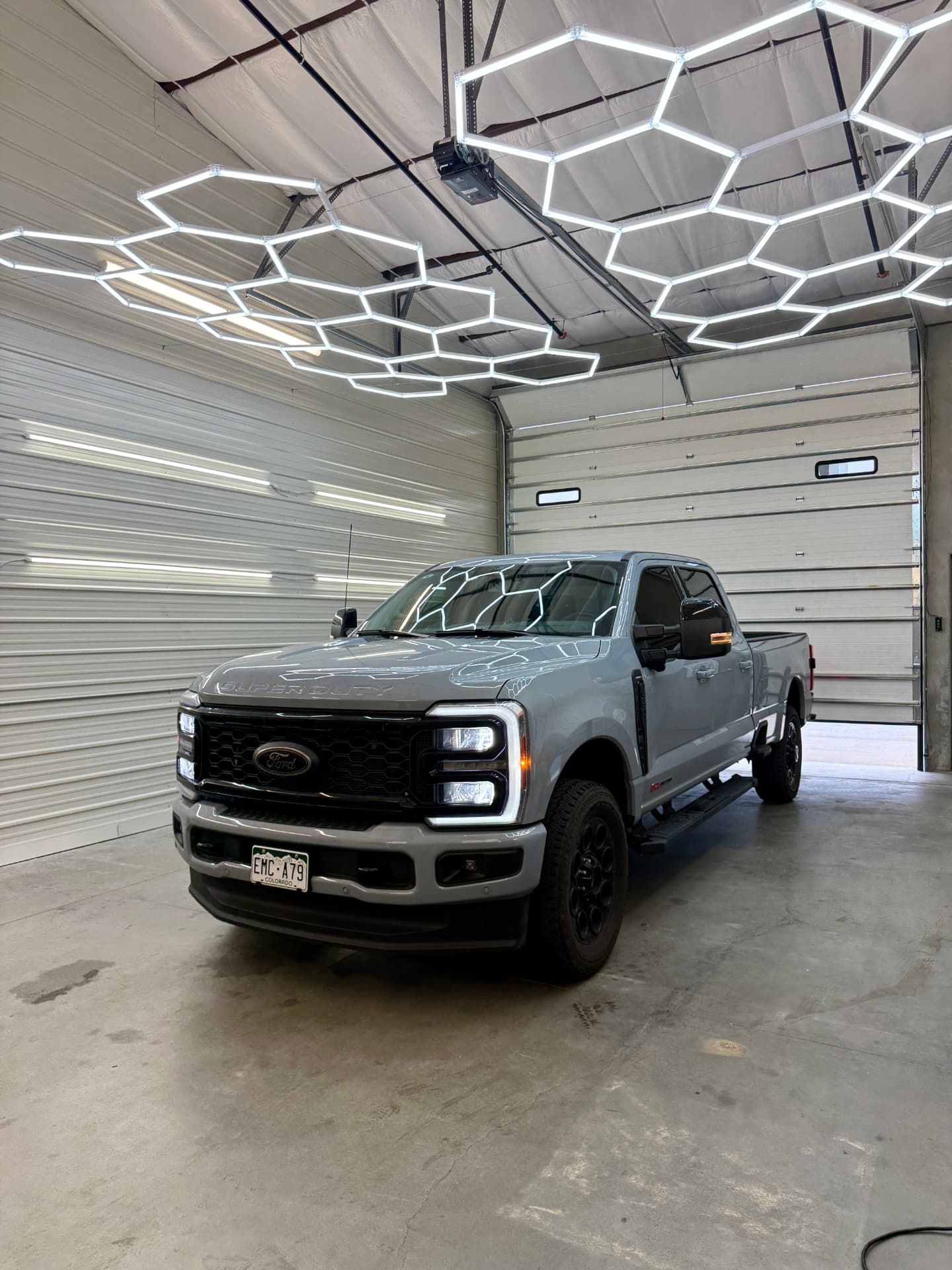 Grey Ford Super Duty with ceramic window tint inside the Hypershade install bay