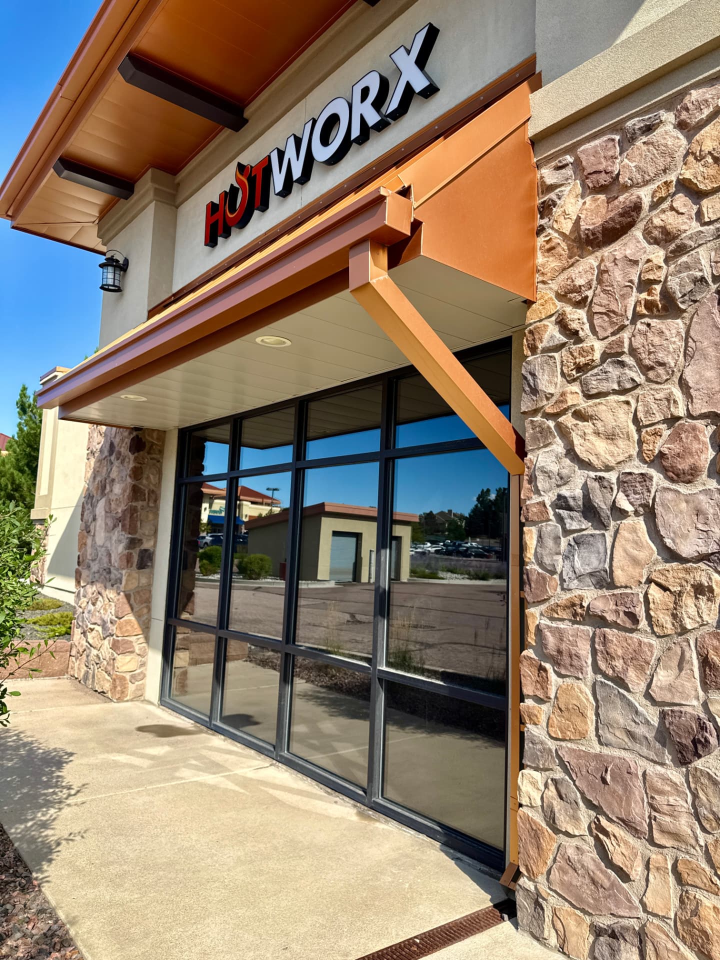 Commercial storefront glass with dark ceramic window film at a Castle Rock retail suite